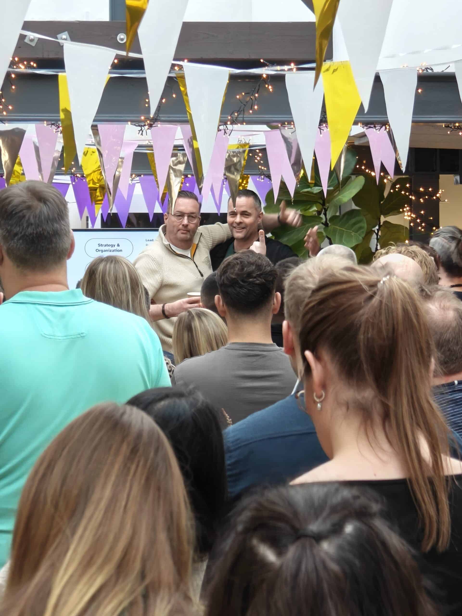 Picture of Omnidocs employees hugging and laughing together